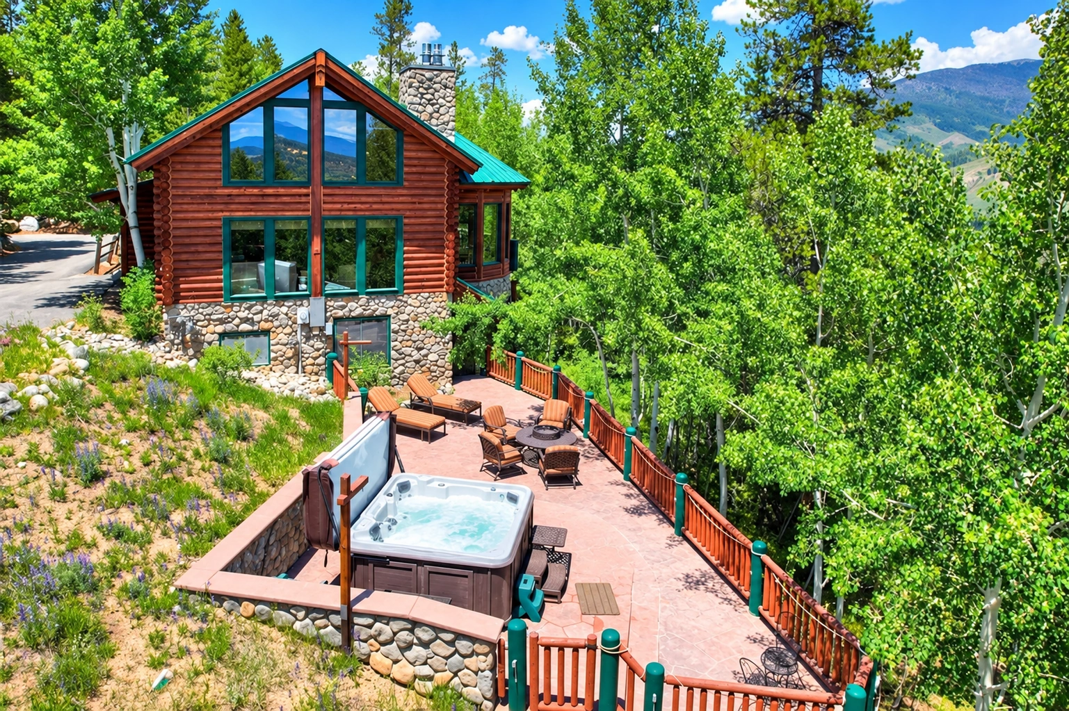 Aerial view of Lincoln Lodge and its expansive deck with a private hot tub