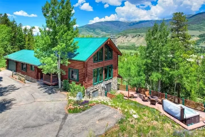 Elevated exterior view of Lincoln Lodge with timber, stone, and mountain backdrop