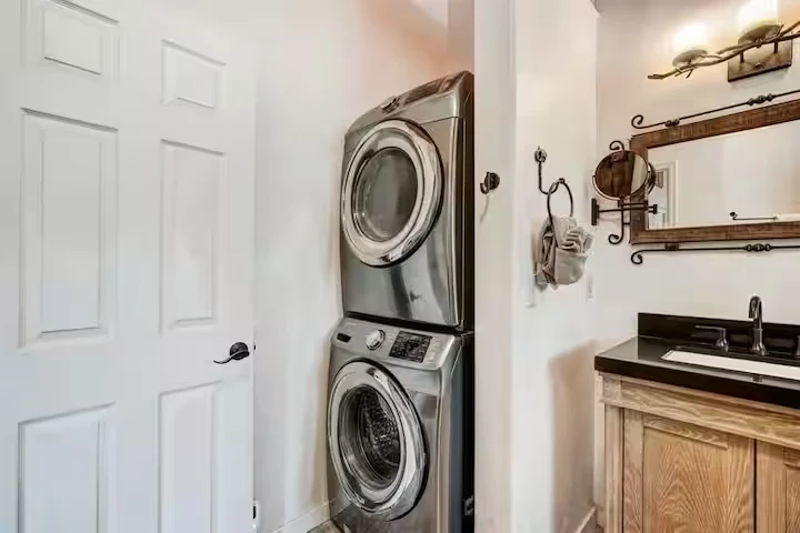 Bathroom vanity beside the stacked washer and dryer at Lincoln Lodge