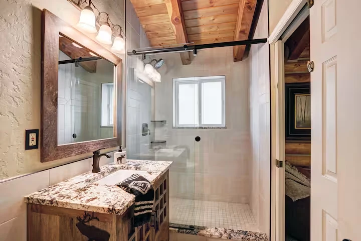 Guest bathroom at Lincoln Lodge with wood vanity and glass shower