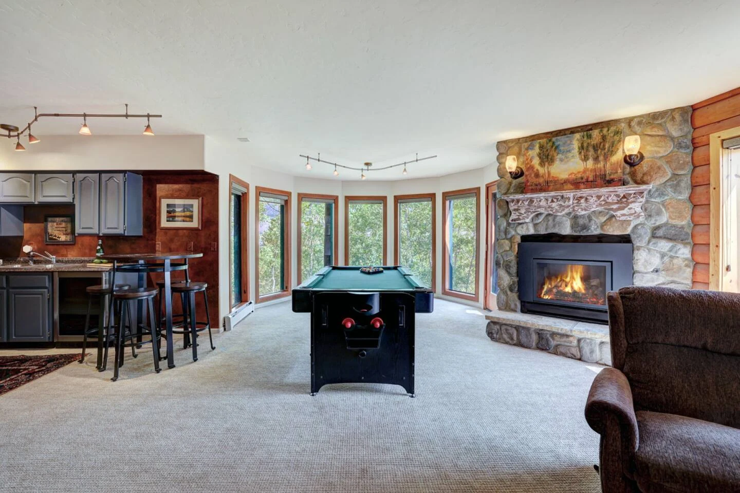 Recreation room with pool table, air hockey, fireplace, and nearby wet bar