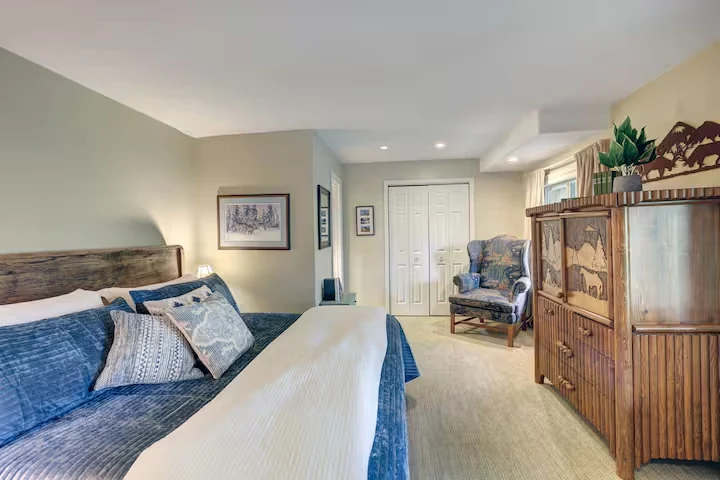Spacious guest bedroom at Lincoln Lodge with layered bedding