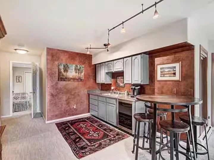 Wet bar with dark cabinetry and bar seating at Lincoln Lodge