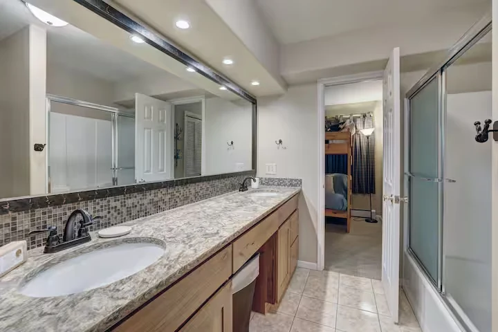Long double vanity and glass shower in a Lincoln Lodge bathroom
